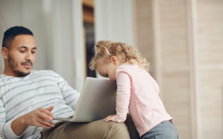 dad with daughter and computer