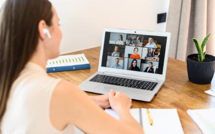 young professional female on video conference in front of computer